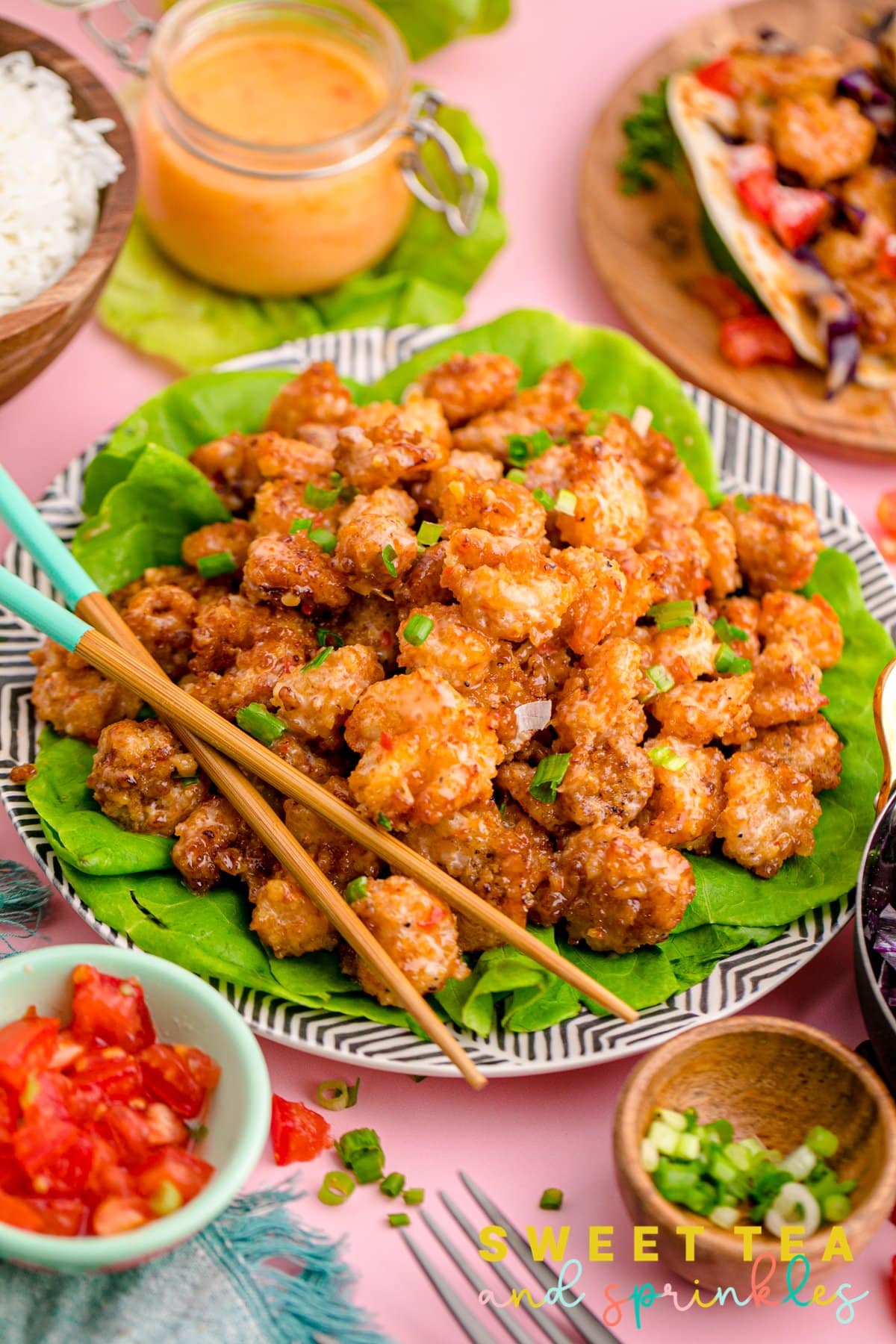 Plated Copycat Bang Bang Shrimp Recipe with chopsticks and ingredients surrounding plate.