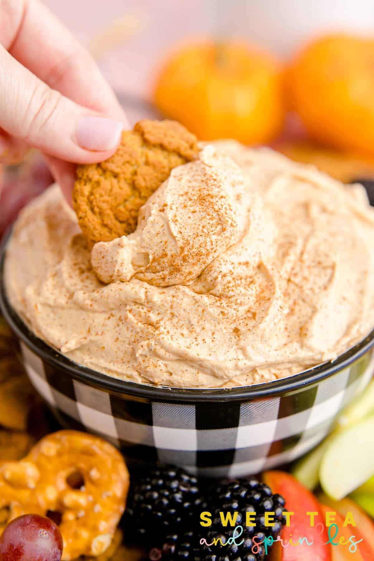 Hand scooping gingersnap into some of the Pumpkin Fluff