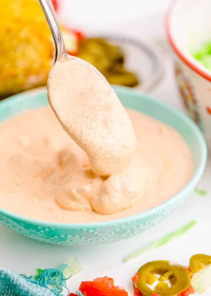 Taco Bell Copycat Creamy Jalapeno Sauce drizzled from a Spoon
