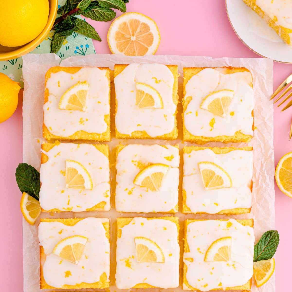 Easy lemon sheet cake slices on parment paper.