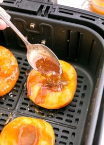 Glaze drizzled on to peaches.