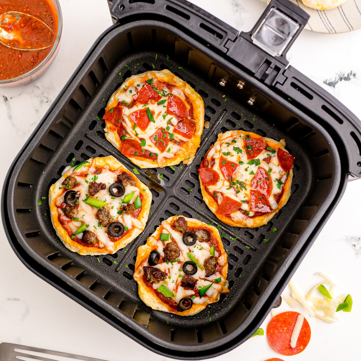 Mini pizzas baked in an air fryer.