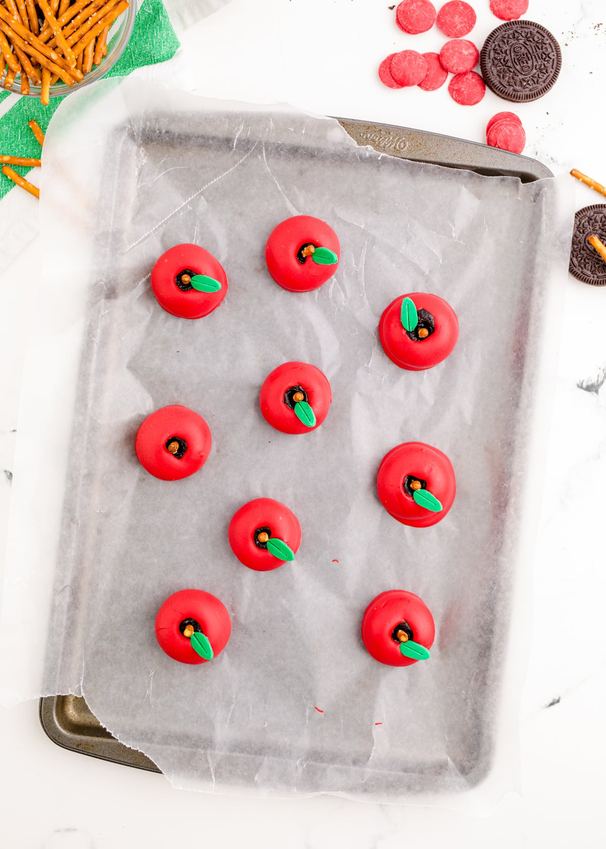 Apple oreo balls on a baking sheet lined with wax paper.