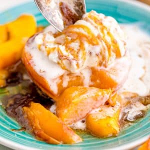 Air fryer peach topped with ice cream and caramel sauce.