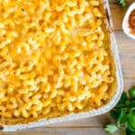 Creamy baked mac & cheese topped with broiled shredded cheese and parsley.