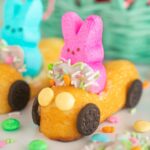 Easter bunny Twinkie cars on a countertop in front of an Easter basket.