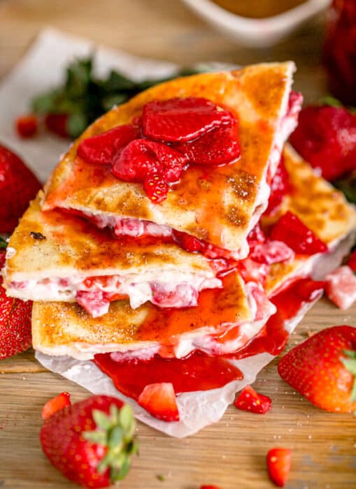 Strawberry cheesecake quesadillas drizzled with strawberry sauce.