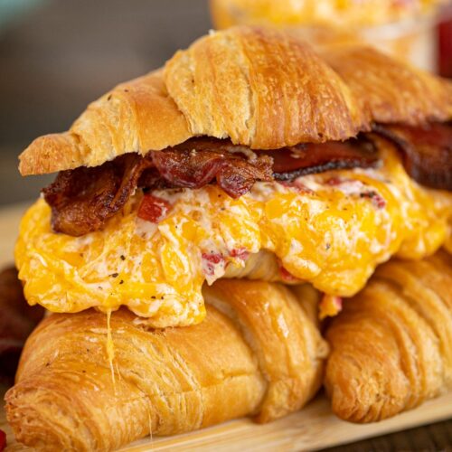 Toasted pimento cheese sandwich on a croissant with bacon.