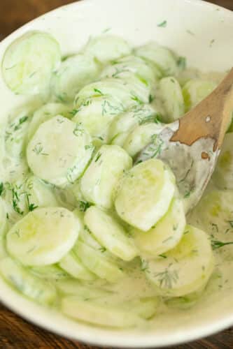 Thinly sliced cucumbers cost in a sour cream and dill dressing.