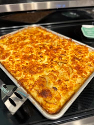 Sheet pan scalloped potatoes topped with a crispy layer of melted sharp cheddar cheese.