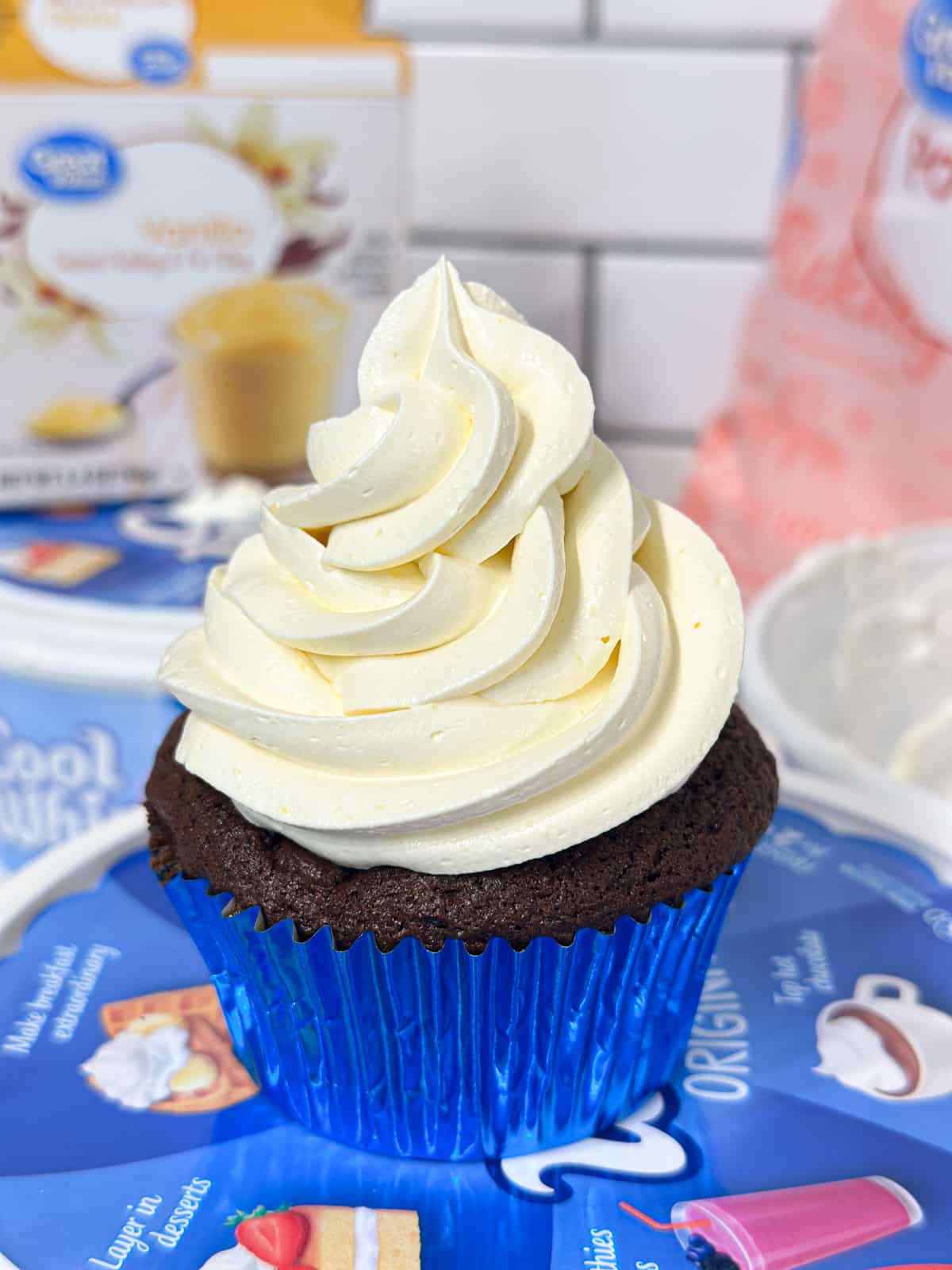 Cool Whip topping piped onto a chocolate cupcake.